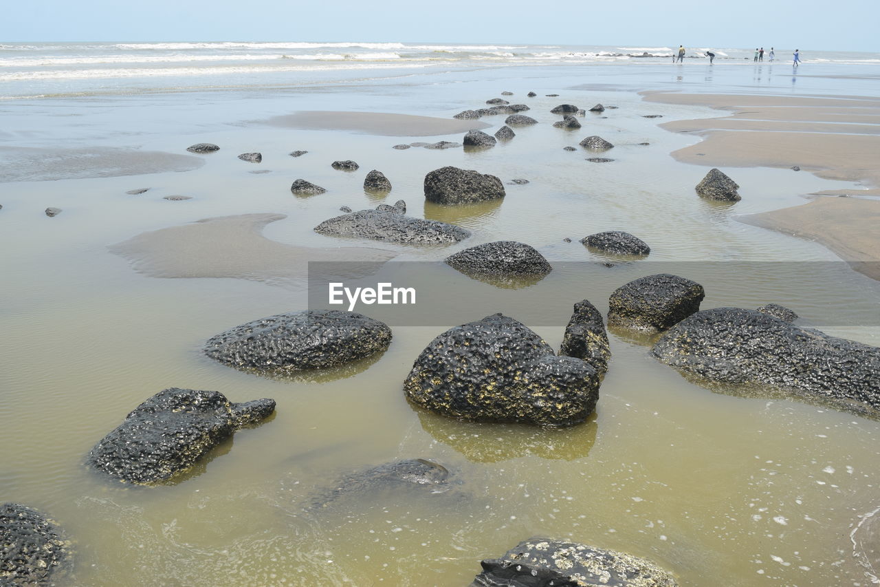 Pebbles on beach against sky