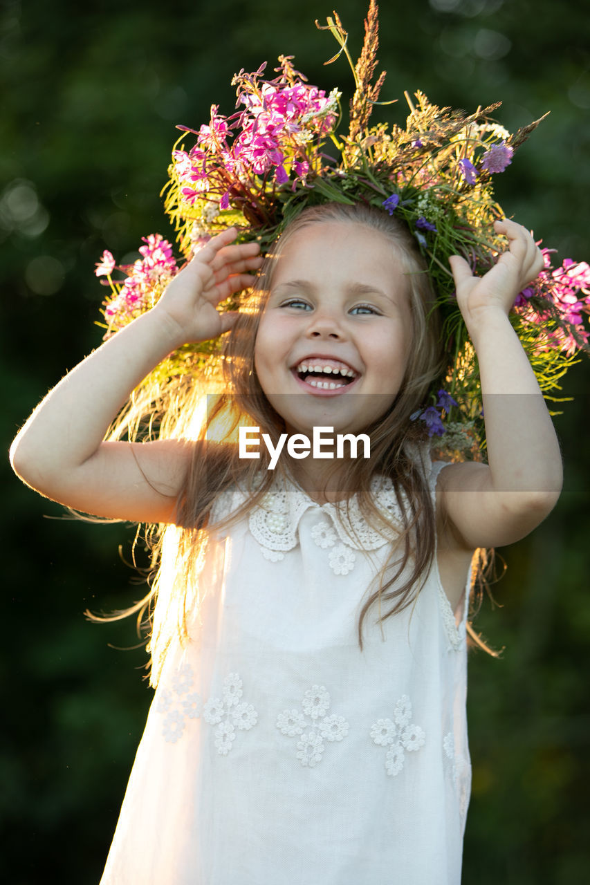 Beautiful little girl in a wreath