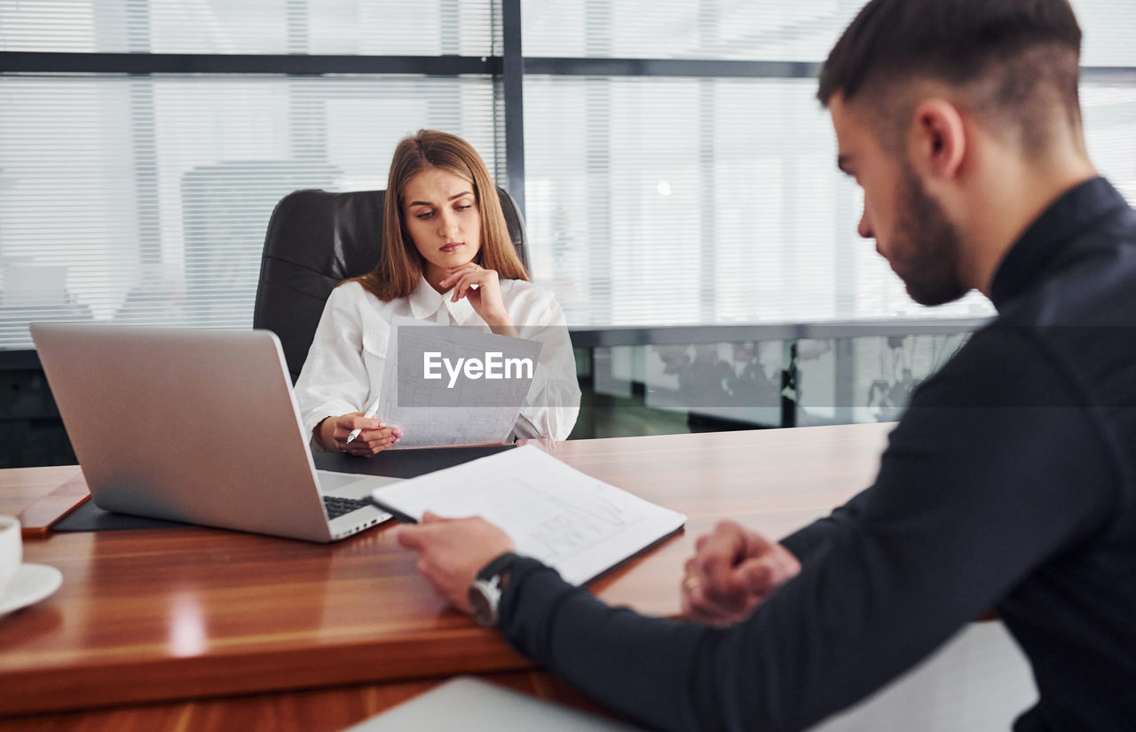 side view of business colleagues working in office