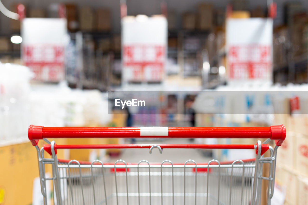 Close-up of red shopping cart in supermarket