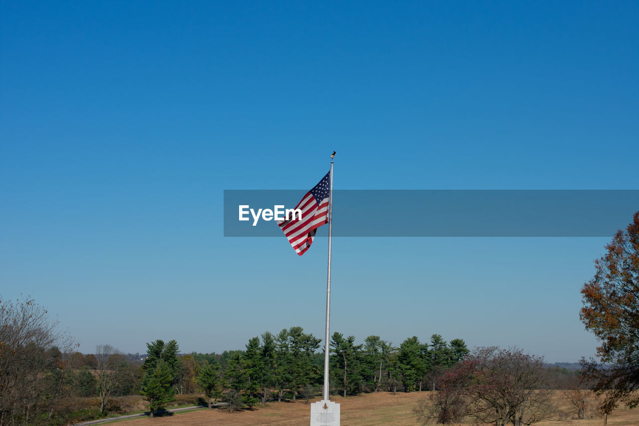 The american flag flying on a clear blue sky at valley forge national historical park