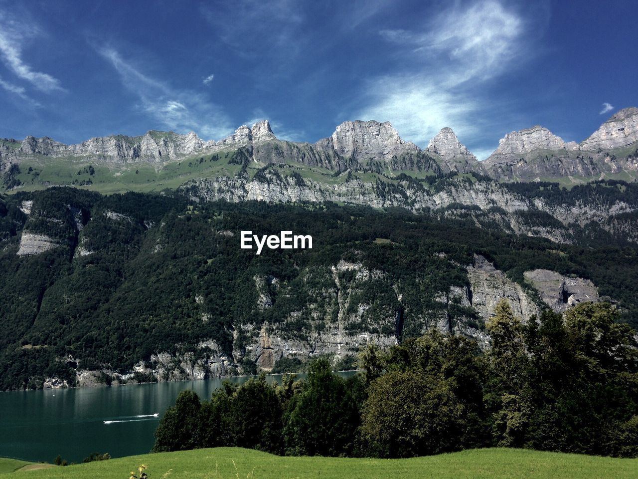 Scenic view of walensee and rocky mountains against sky