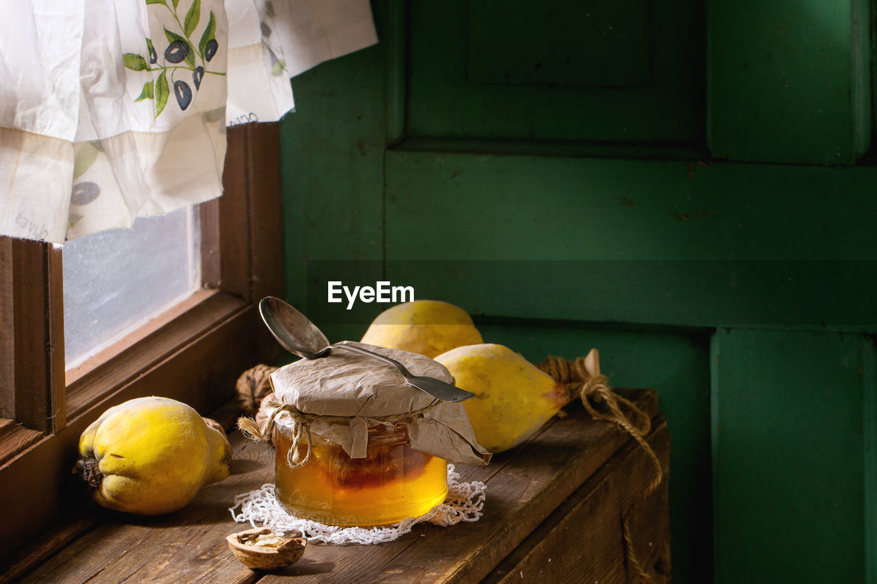 Close-up of quinces with honey on table