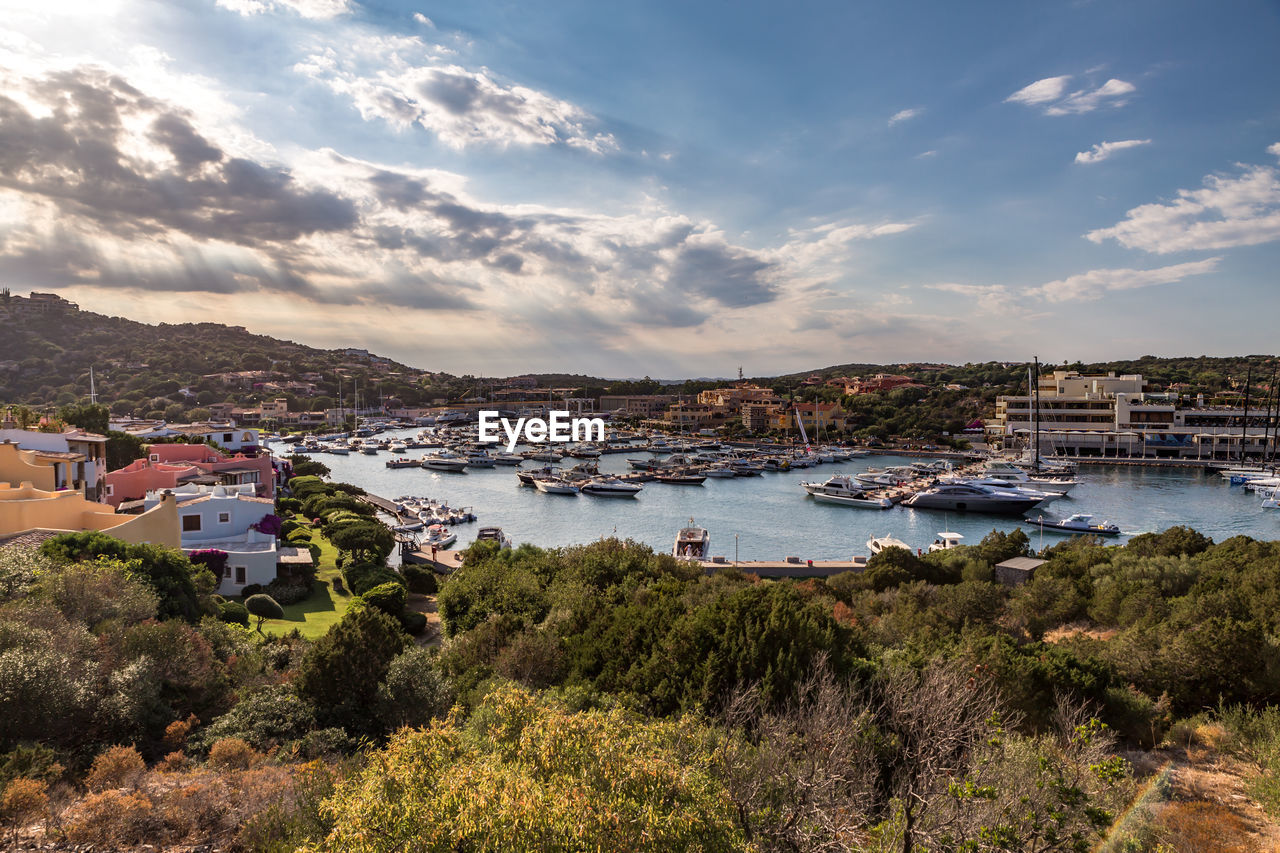 View of town by sea against sky