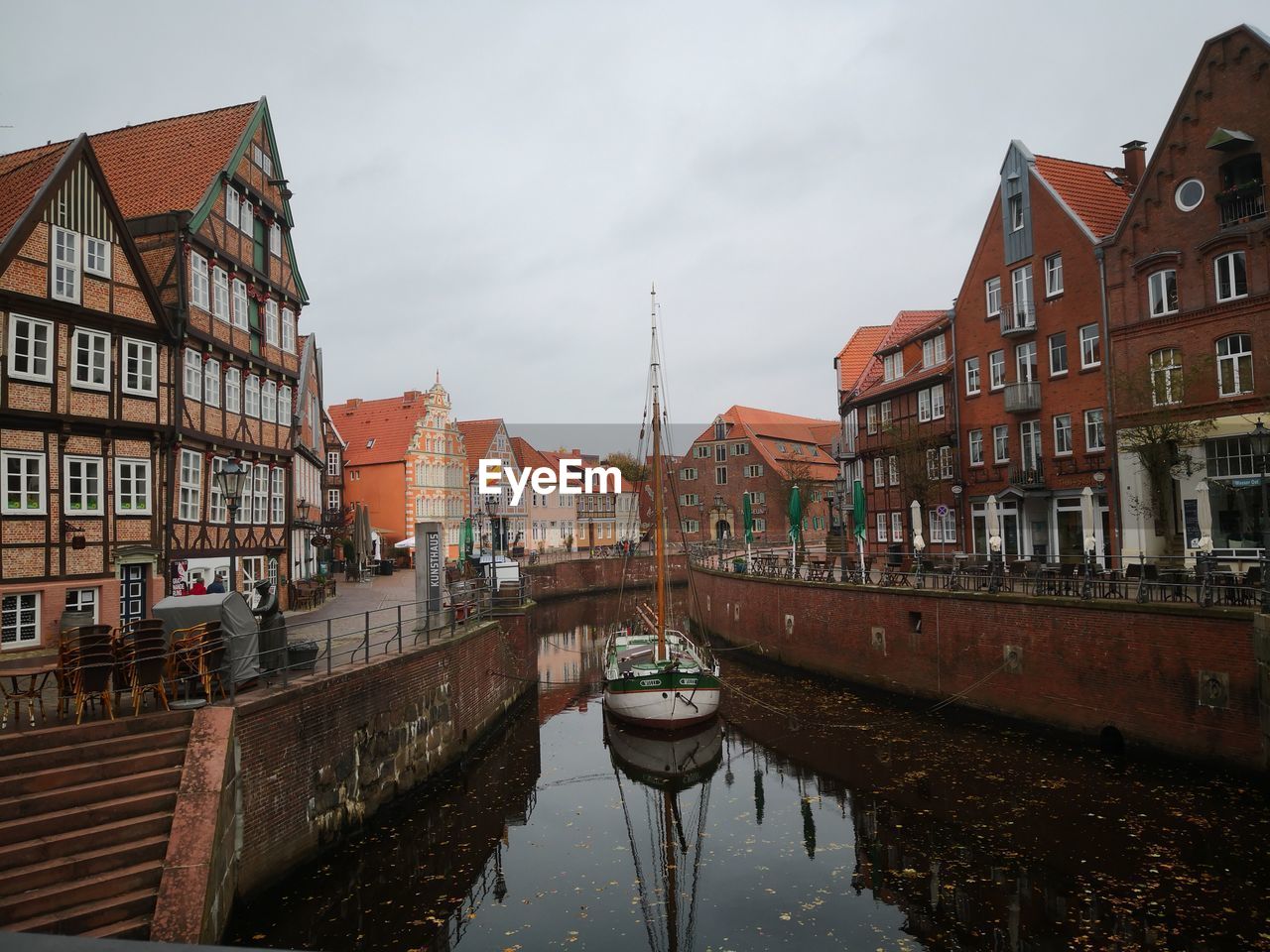 Canal amidst buildings against sky