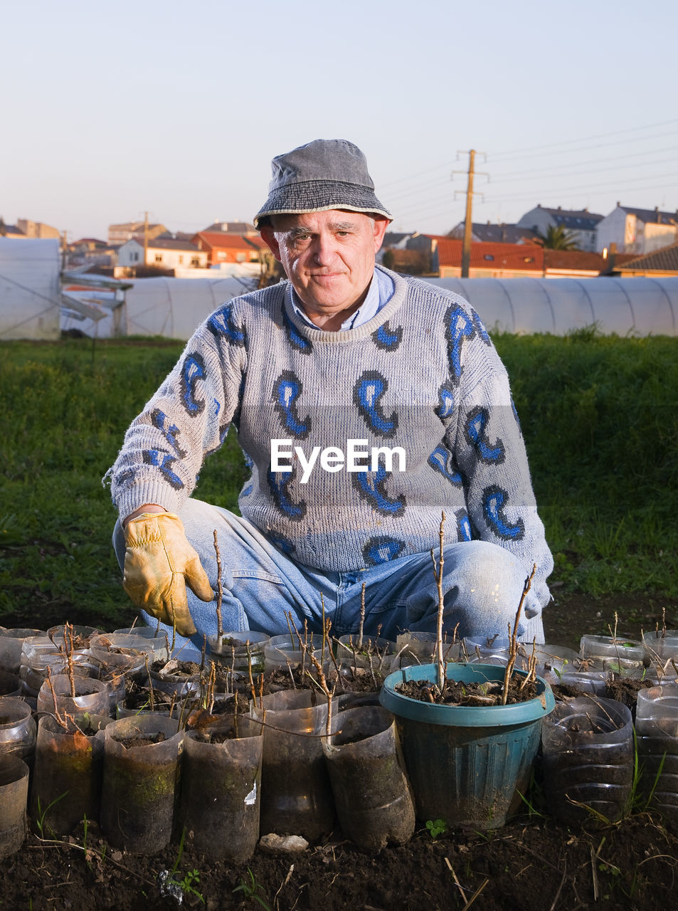 Portrait of man standing on field against sky