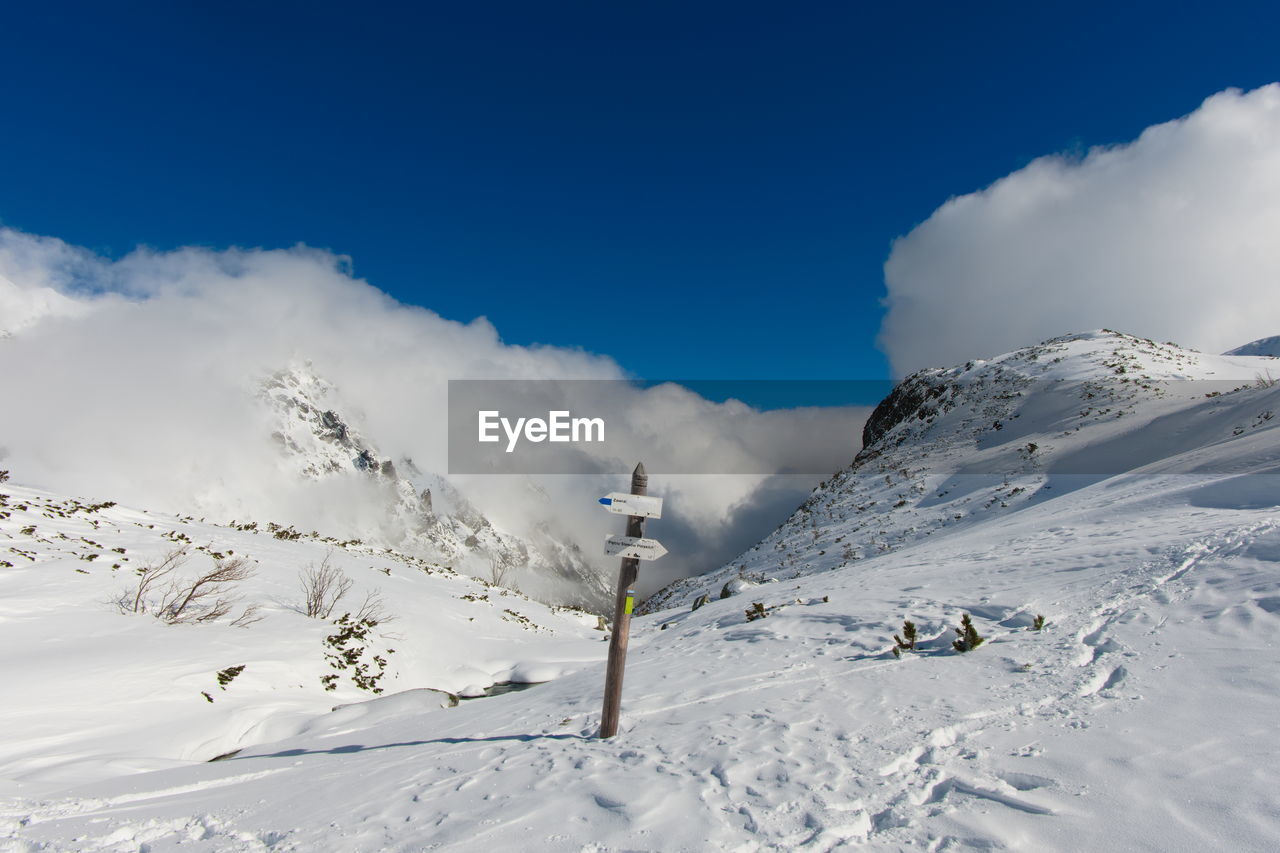 SNOW COVERED MOUNTAINS AGAINST SKY