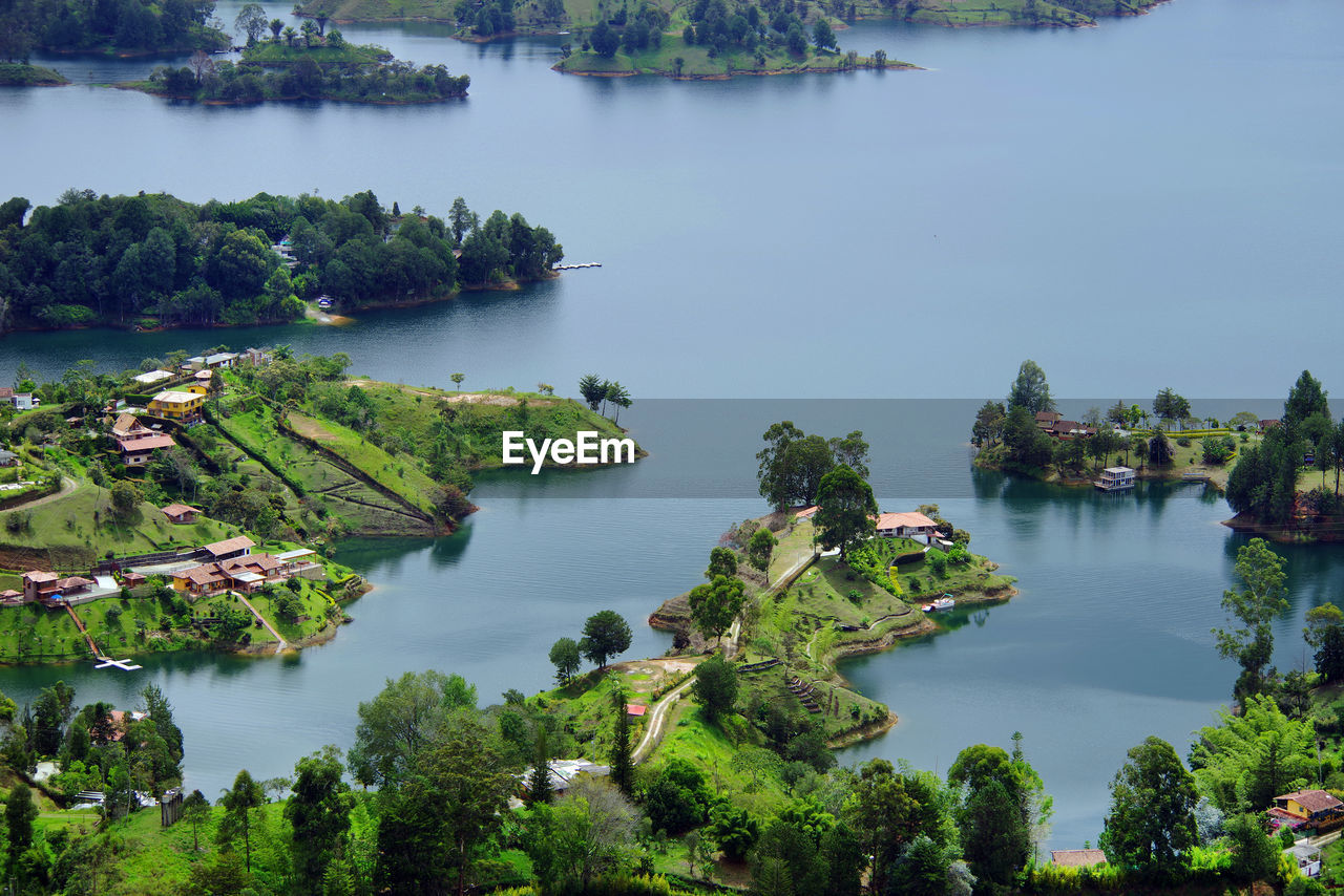 High angle view of trees by lake against sky