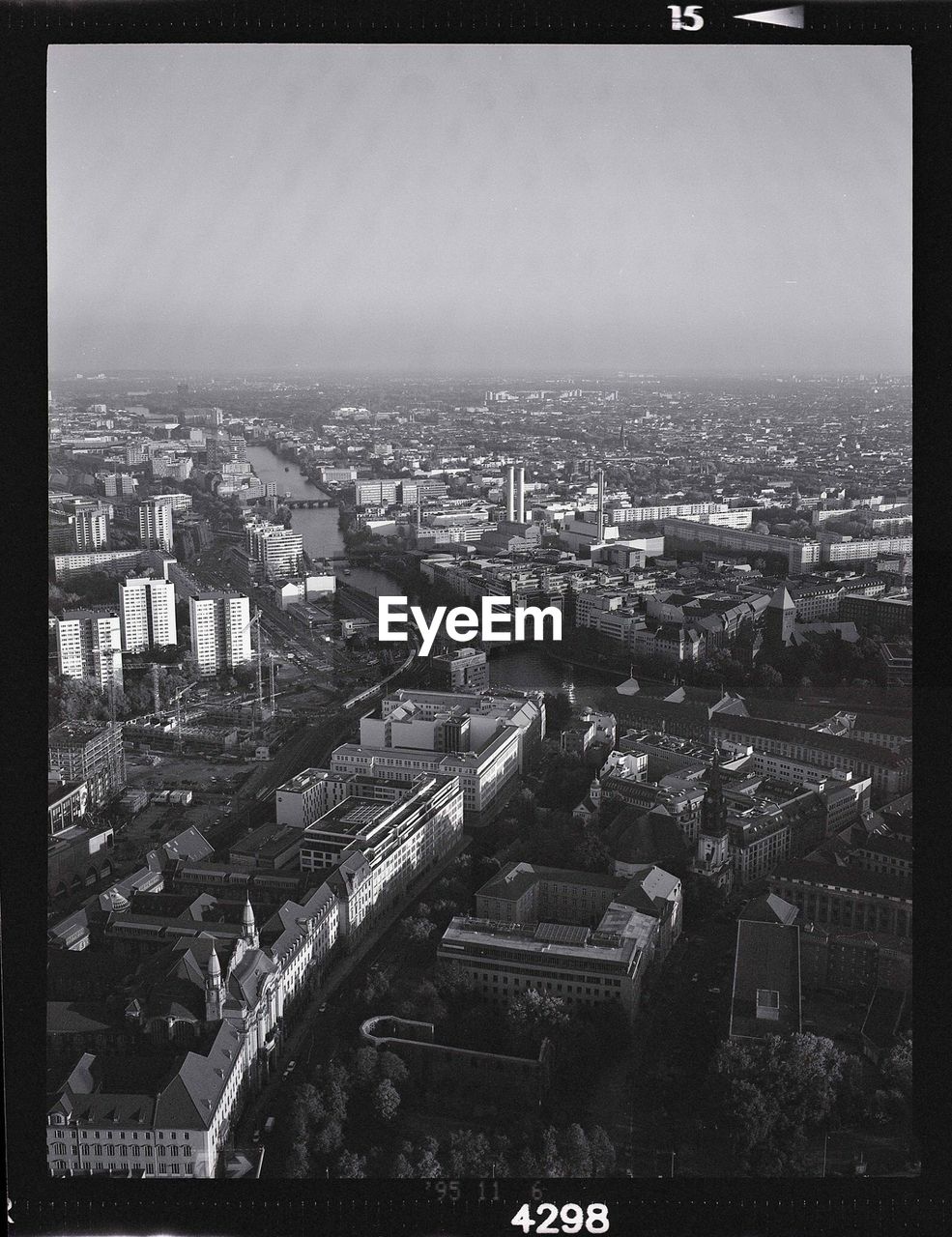 Aerial view of buildings in city against sky