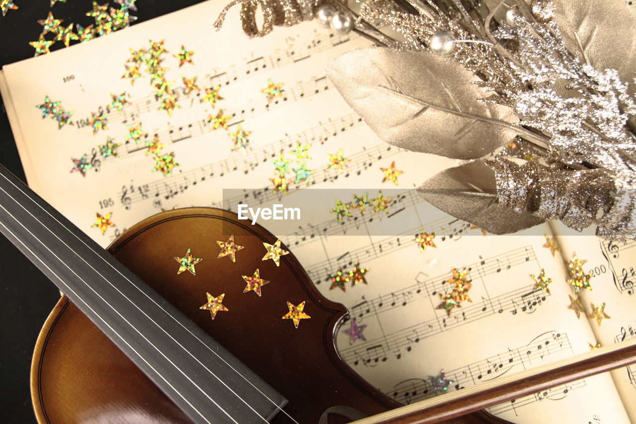 High angle view of violin and decorations on table