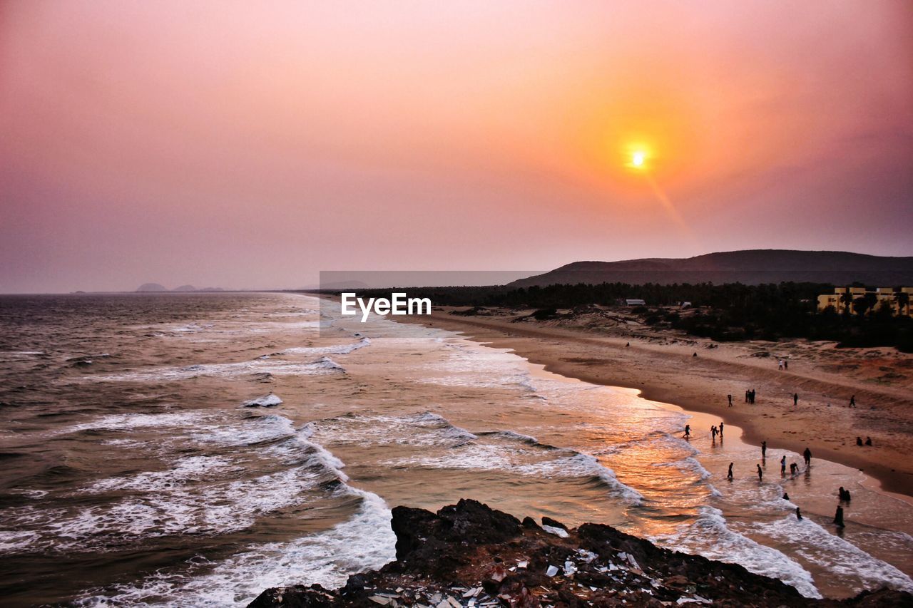 Scenic view of beach against dramatic sky