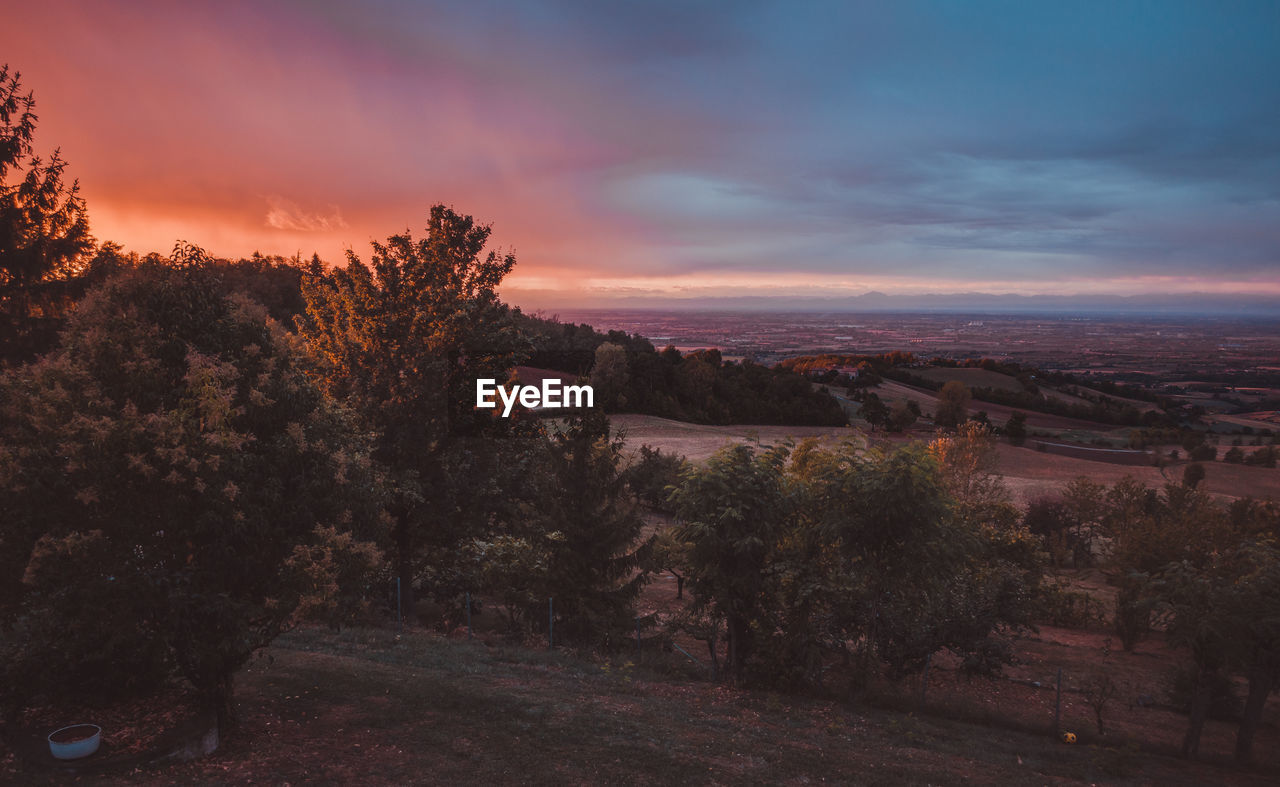 Scenic view of townscape against sky at sunset