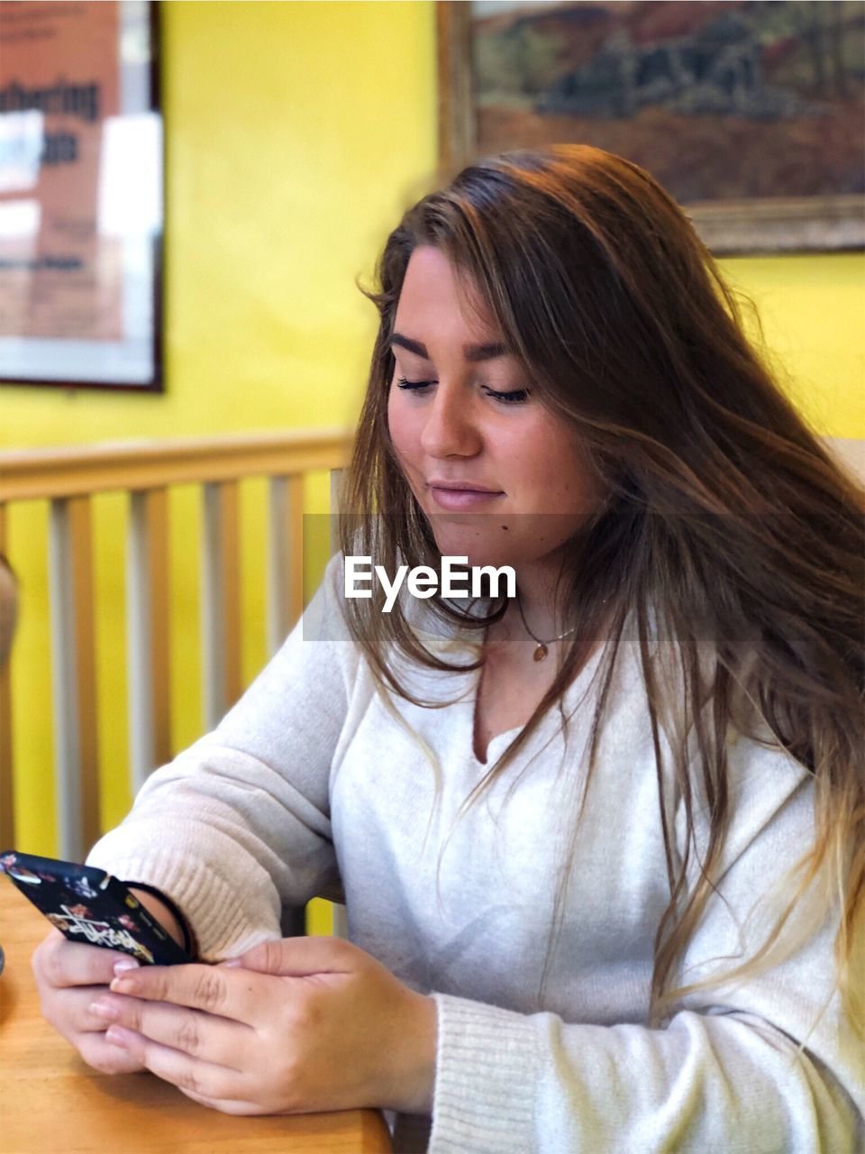 Close-up of young woman using mobile phone