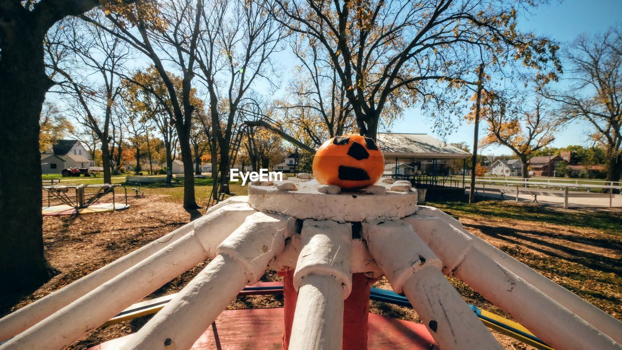 Halloween pumpkin on outdoor play equipment at playground