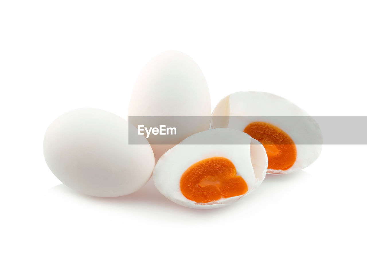 CLOSE-UP OF EGGS OVER WHITE BACKGROUND AGAINST GRAY