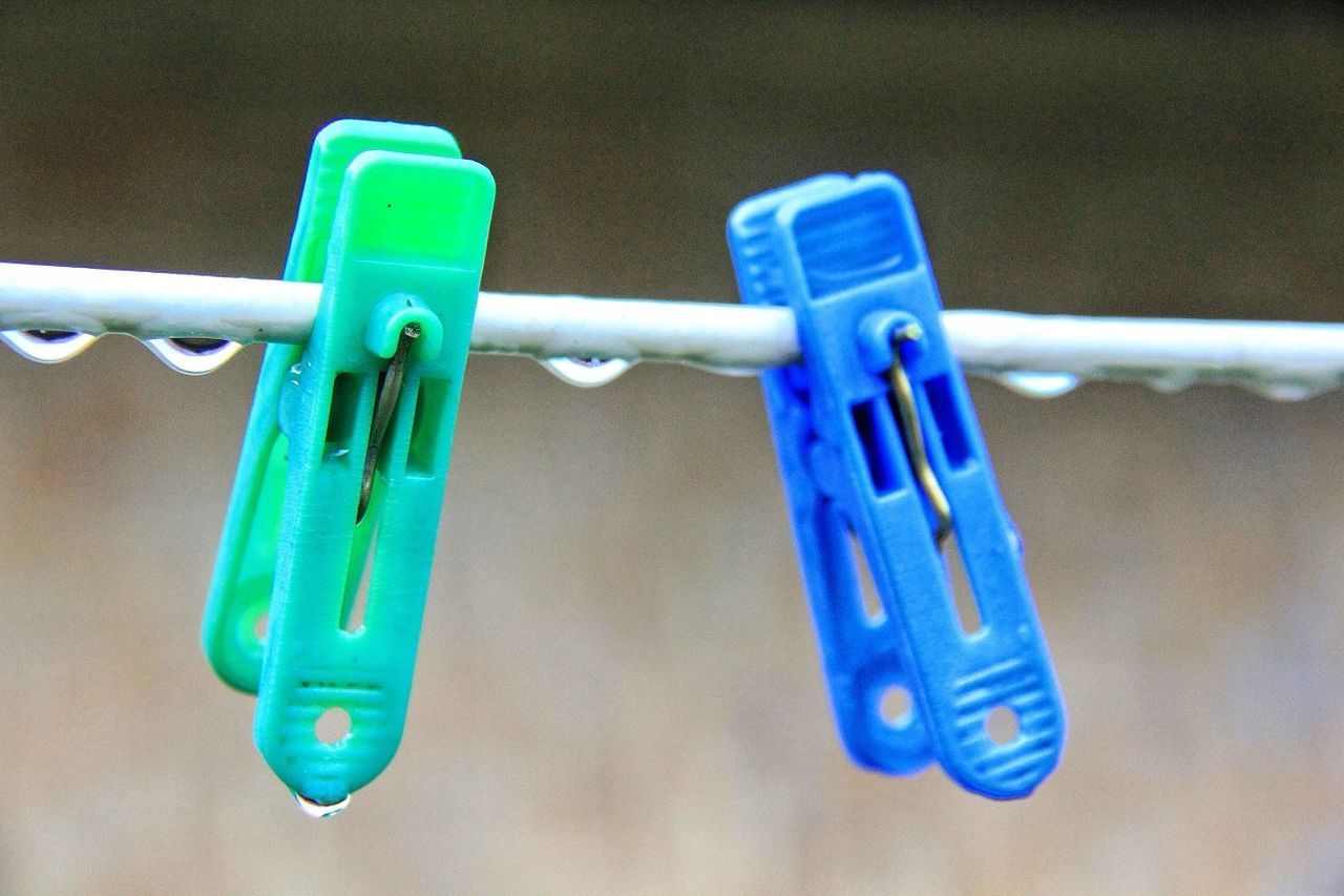 Blue and green clips on clothesline