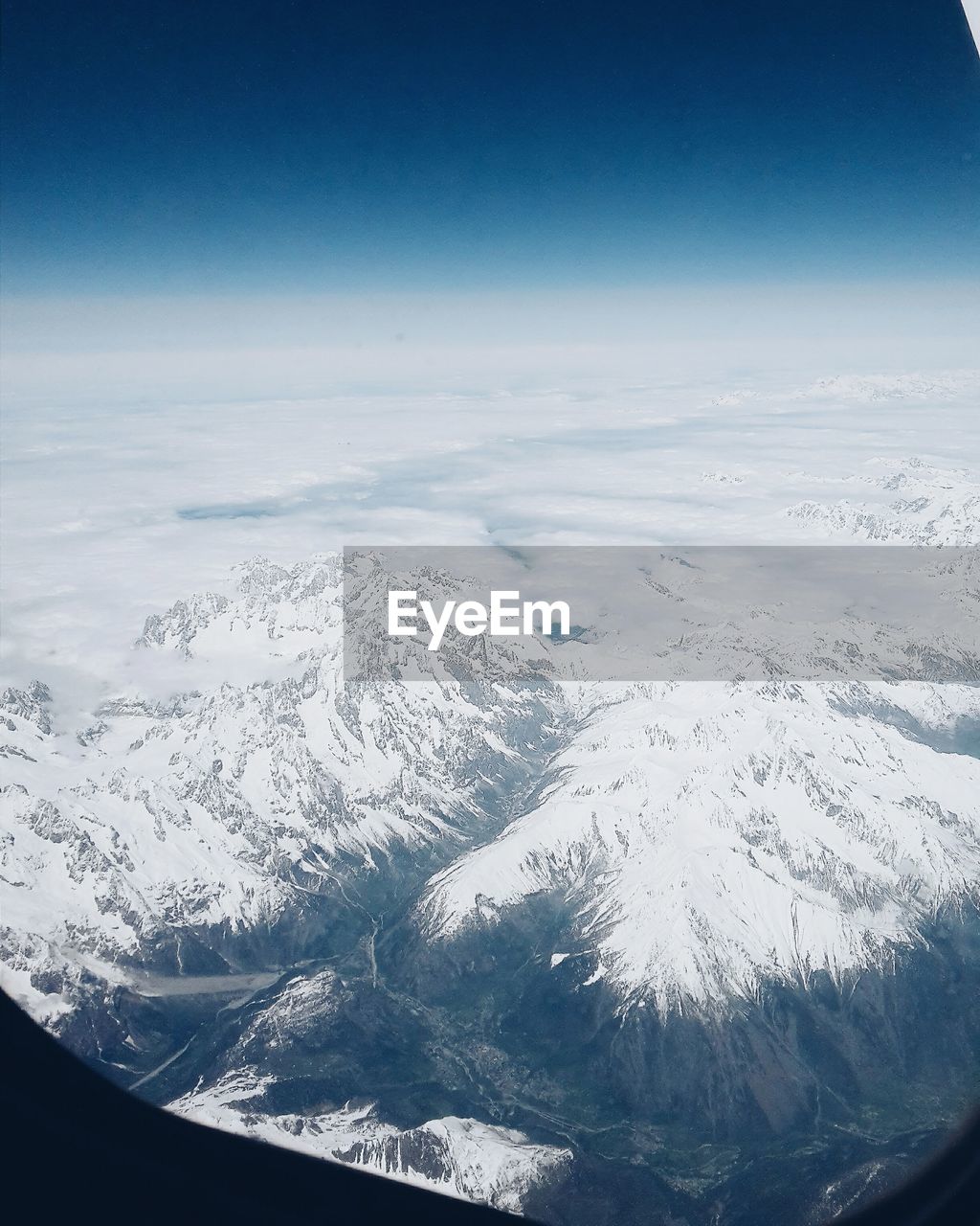 AERIAL VIEW OF LANDSCAPE AND MOUNTAINS AGAINST SKY