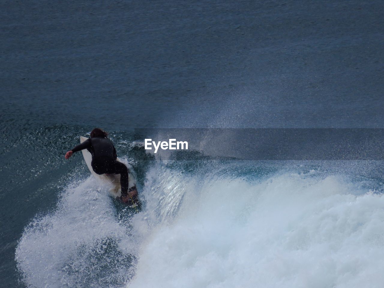 Man surfboarding in sea against sky