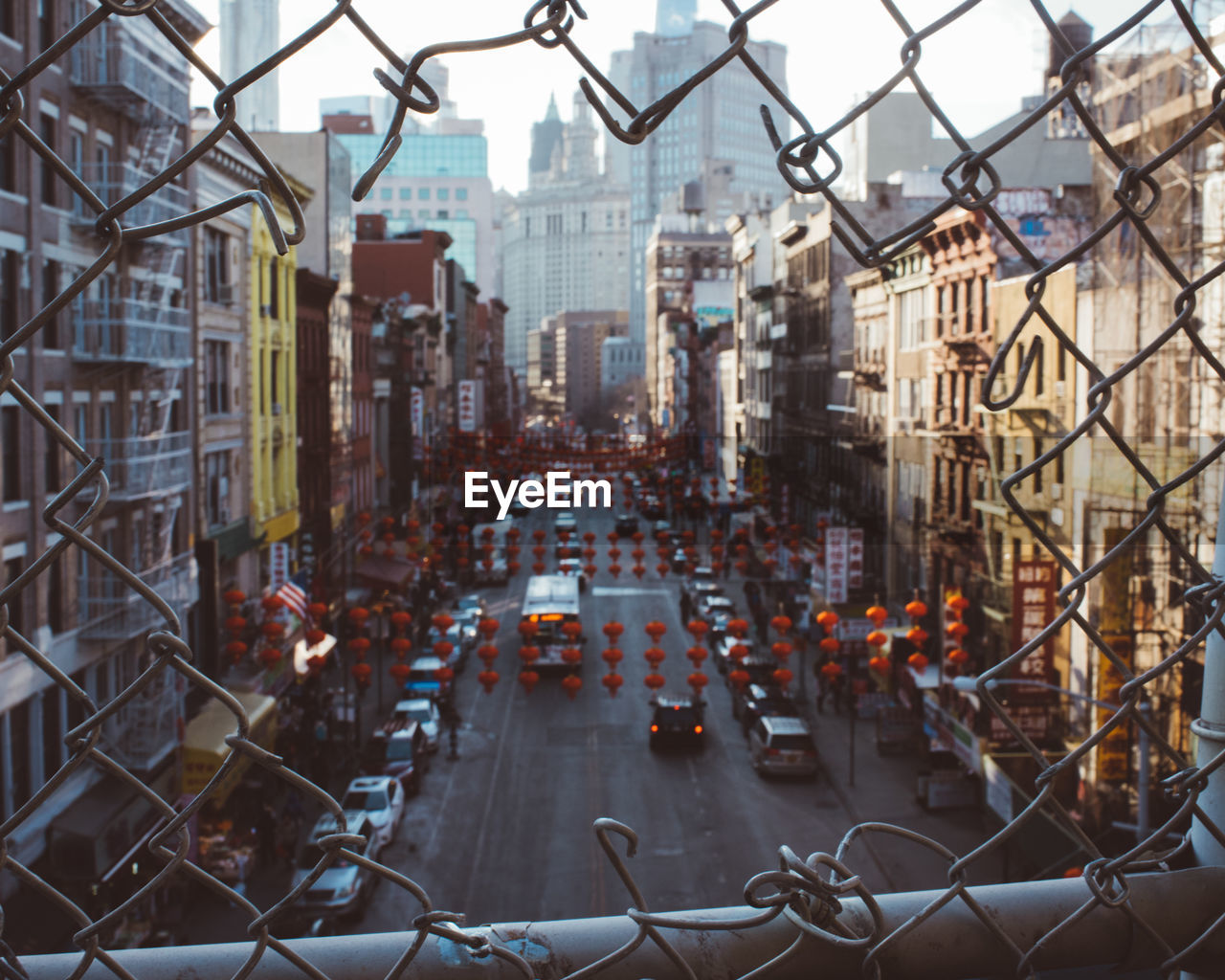 Aerial view of city street seen through chainlink fence