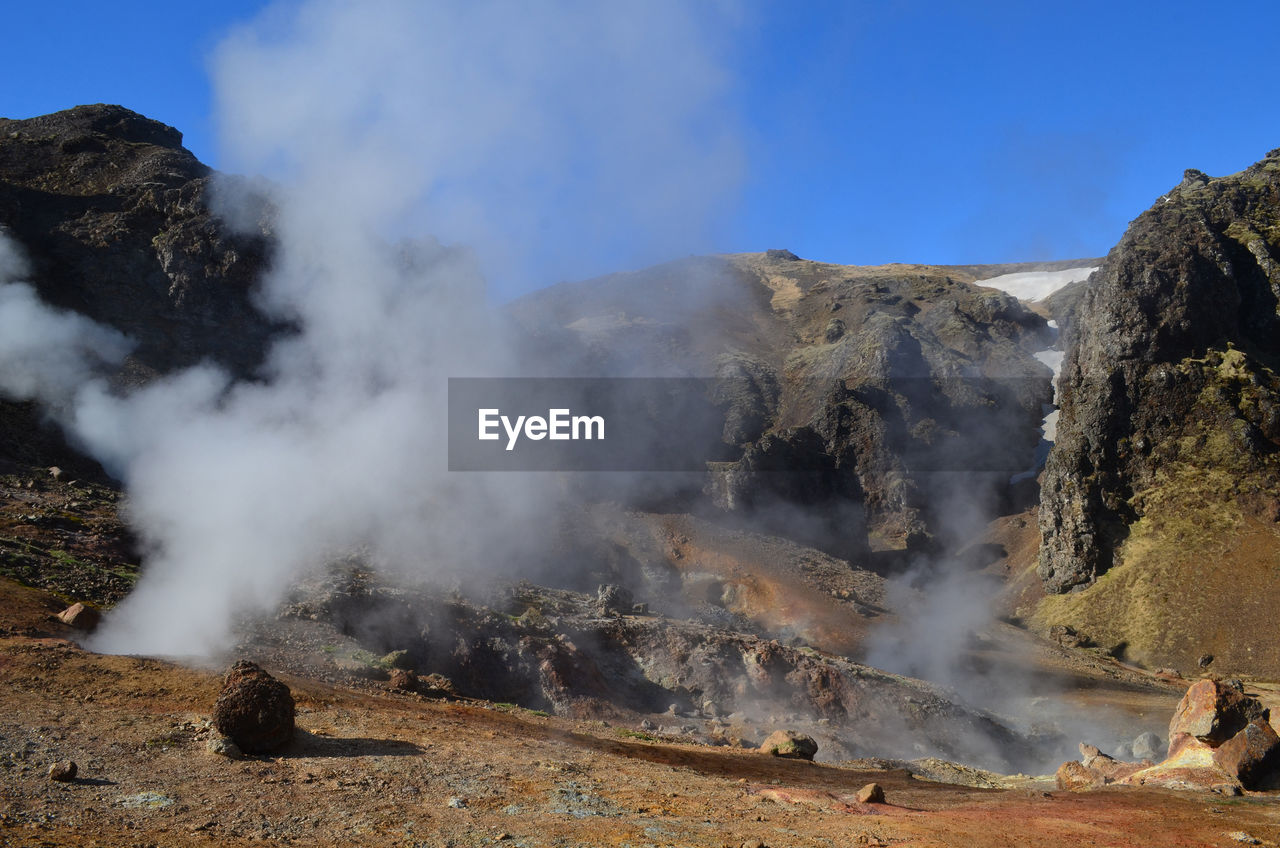Hot steam billowing up from the volcanic landscape of hveragerdi.