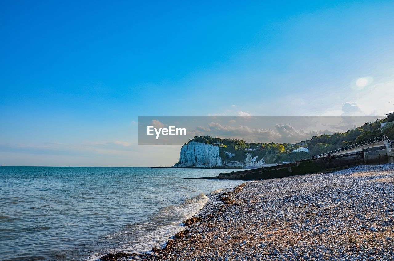 Scenic view of sea against blue sky