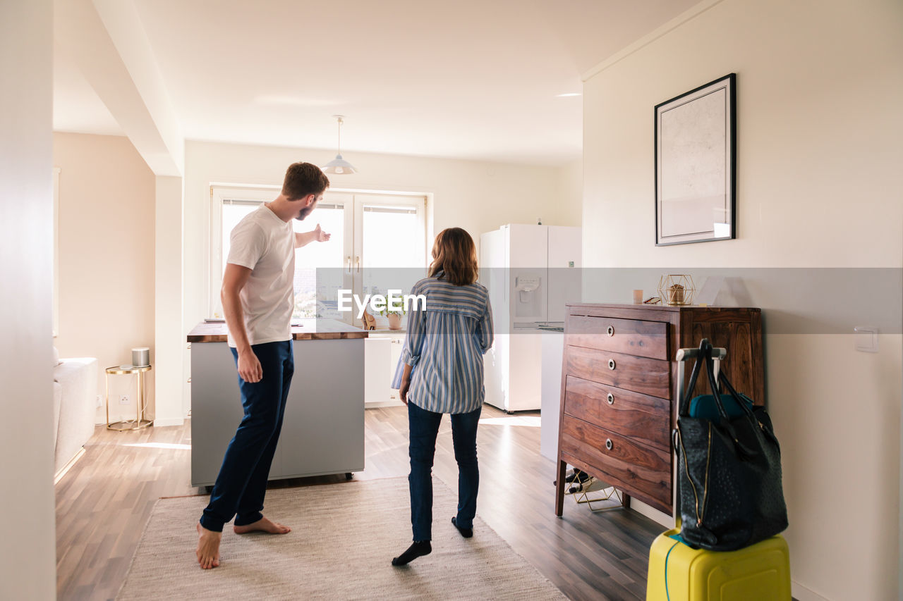 Landlord showing apartment to woman during summer