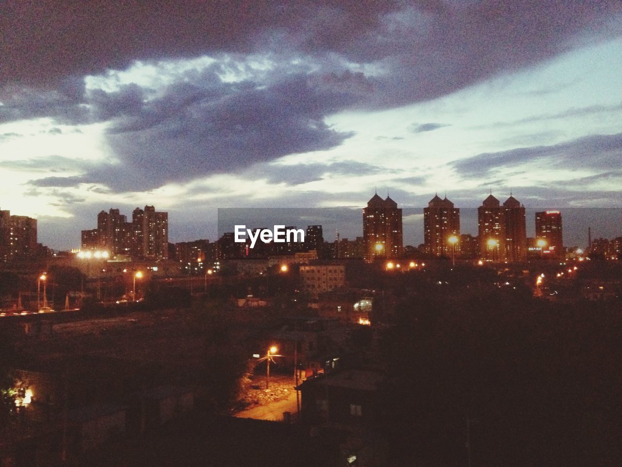 ILLUMINATED BUILDINGS AGAINST SKY AT NIGHT