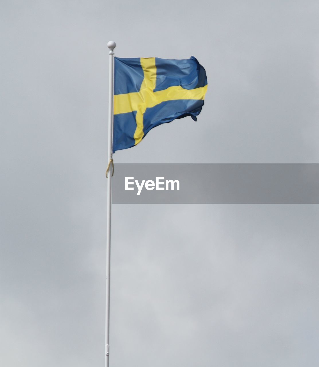 LOW ANGLE VIEW OF FLAGS AGAINST SKY