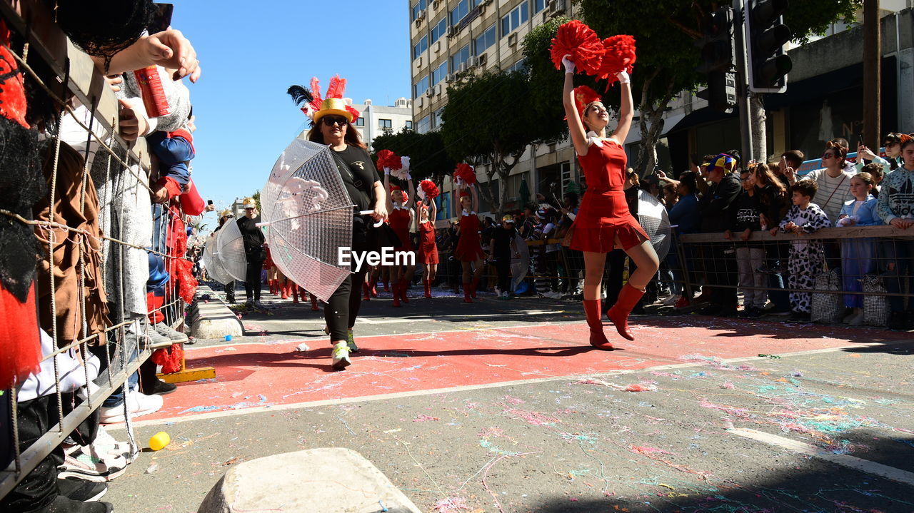 PEOPLE ON STREET IN CITY DURING FESTIVAL