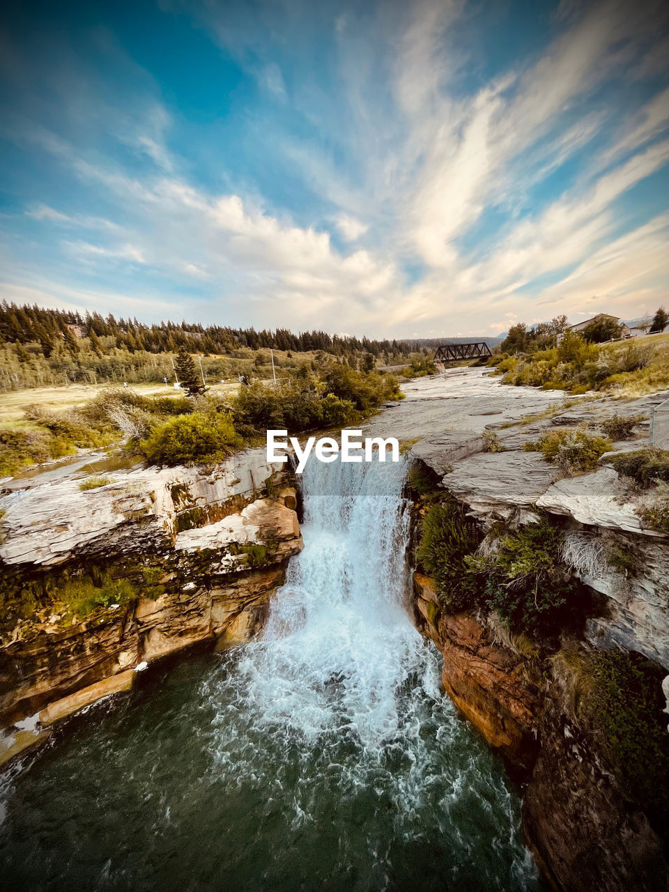 Scenic view of waterfall against sky