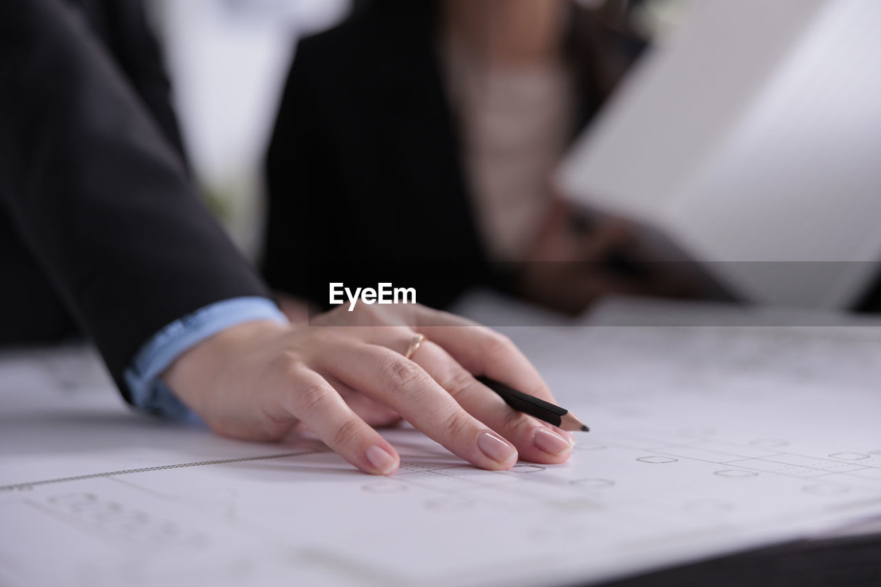 midsection of businessman working at desk