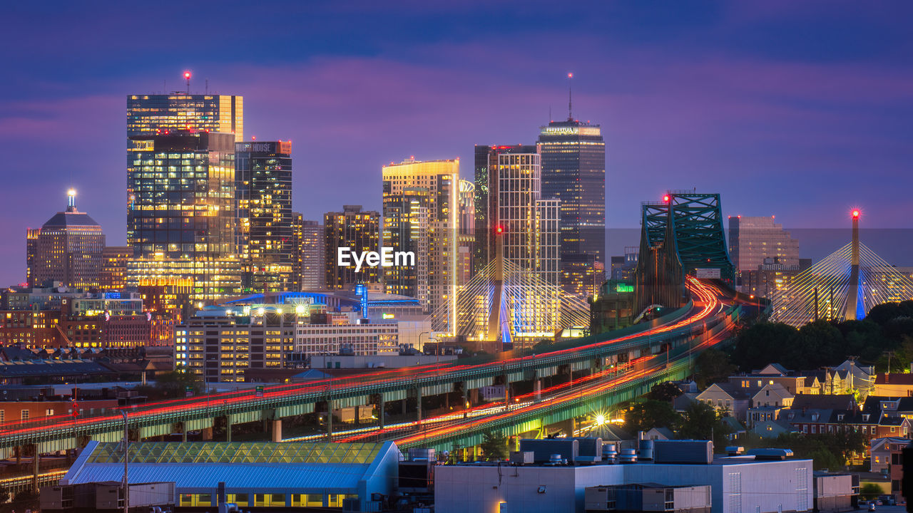 Highway traffic and city skyline at night