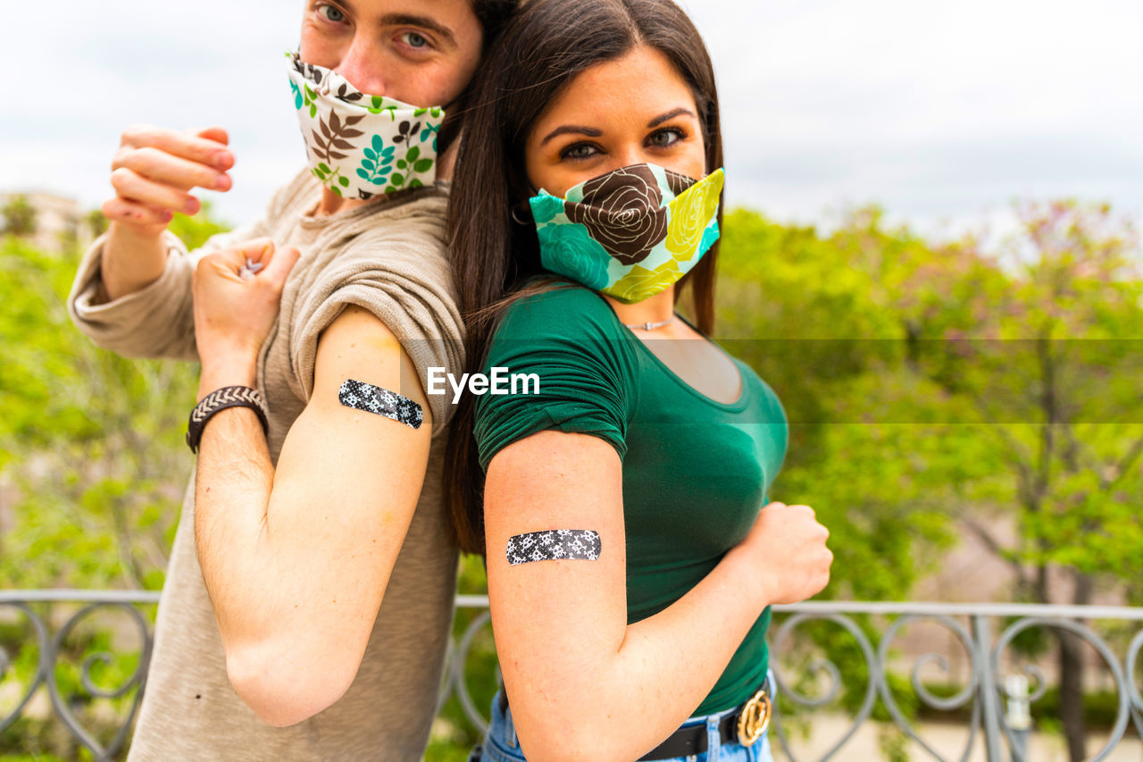 Boy shows the patch after getting vaccine. man using adhesive bandage plaster on her arm after 