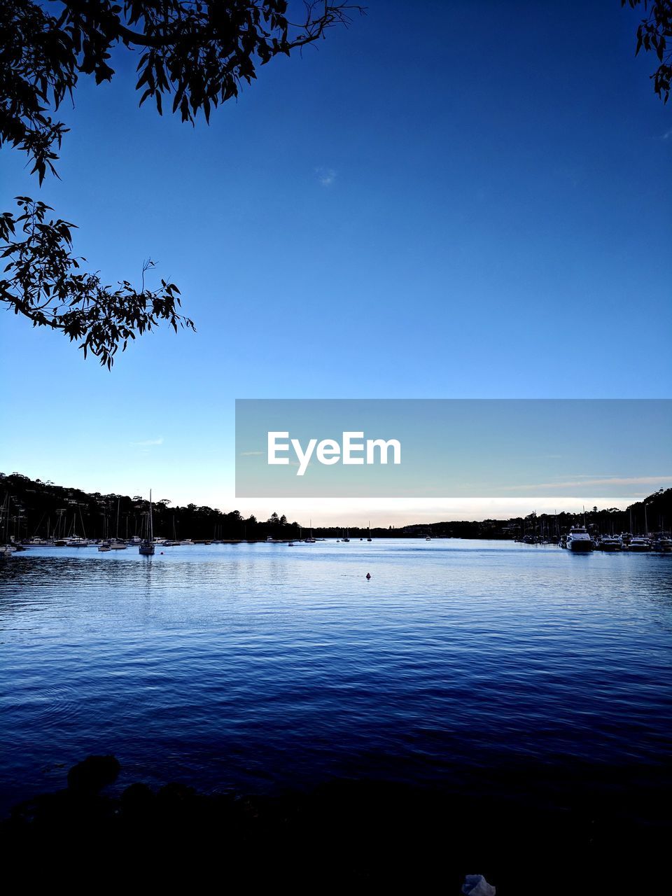 VIEW OF LAKE AGAINST CLEAR BLUE SKY