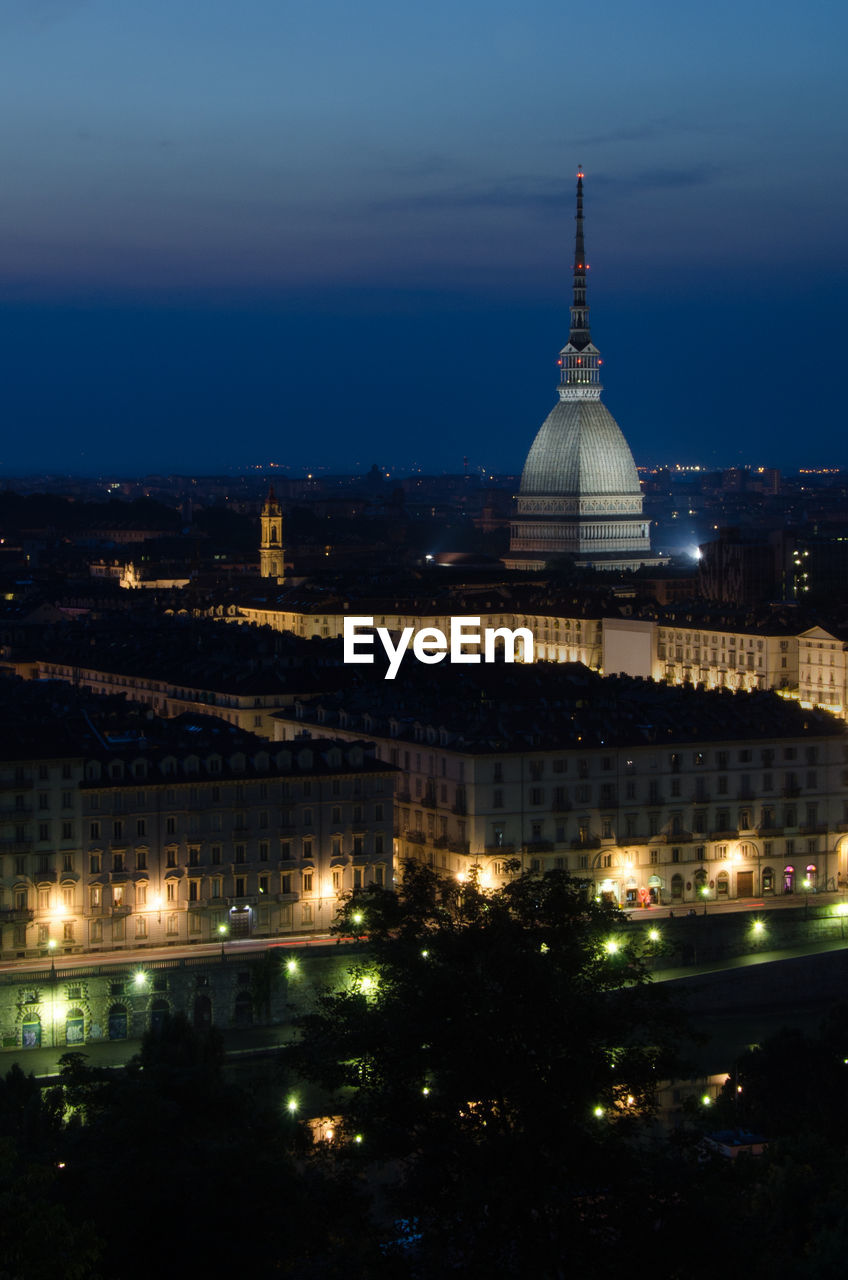 Mole antonelliana with cityscape against sky at night