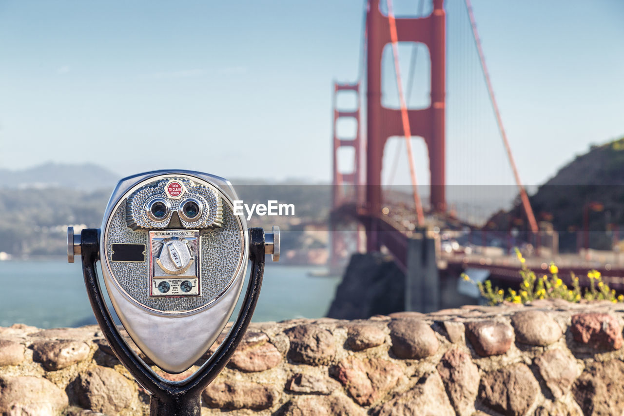 CLOSE-UP OF COIN-OPERATED BINOCULARS ON SEA