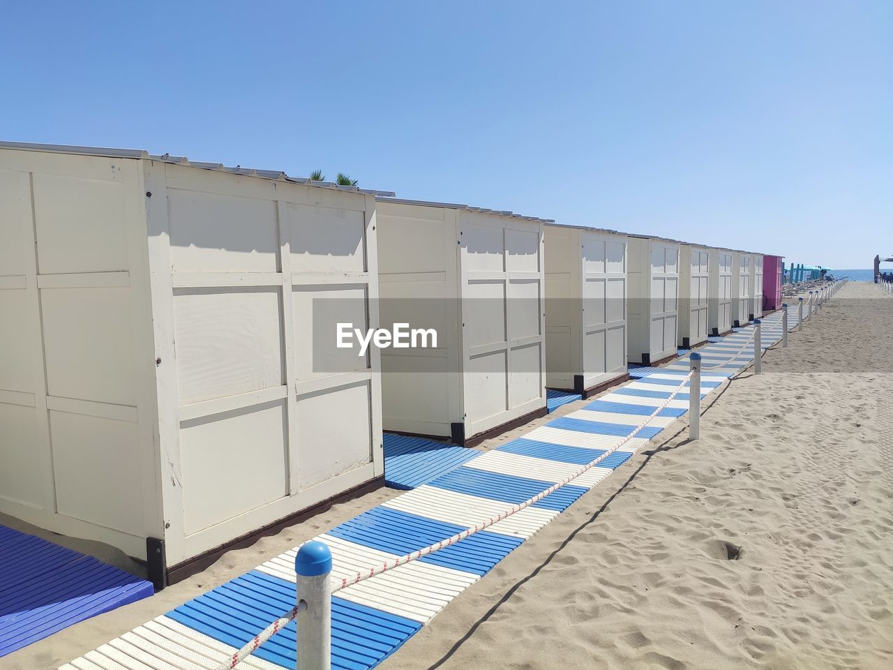 ROW OF BUILDING ON BEACH AGAINST CLEAR SKY