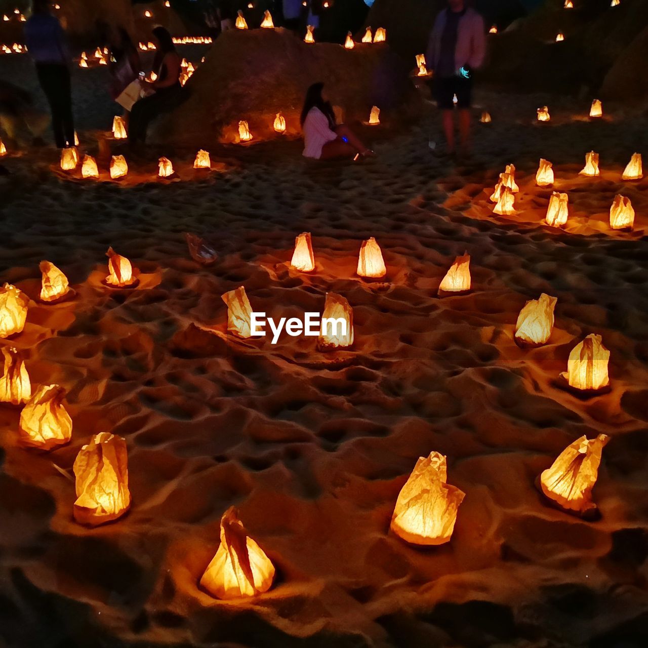 High angle view of illuminated lighting equipment on sand at night