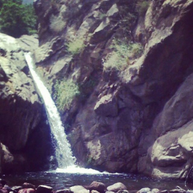 SCENIC VIEW OF WATERFALL AGAINST SKY