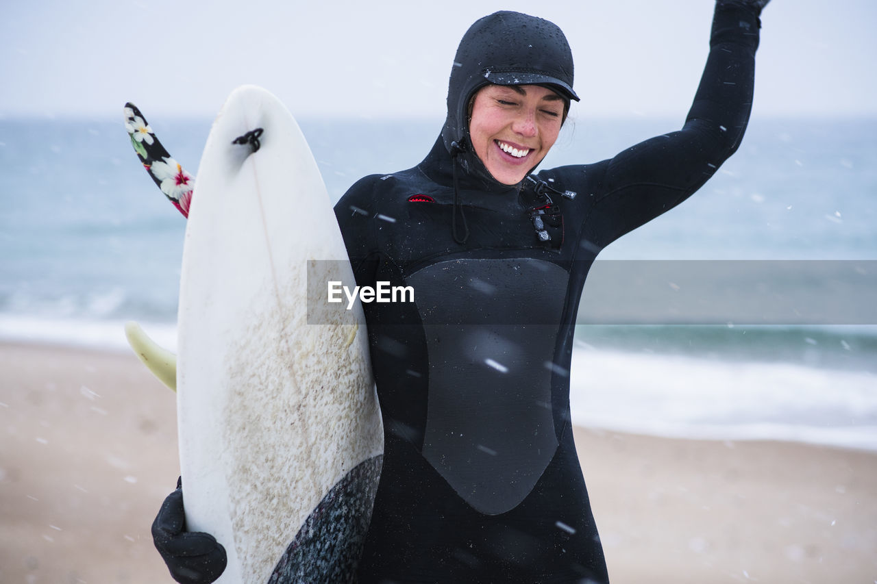 Young woman going winter surfing in snow