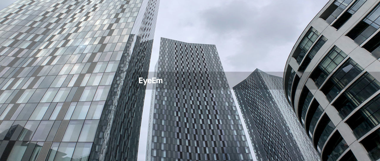 Low angle view of modern buildings against sky in city