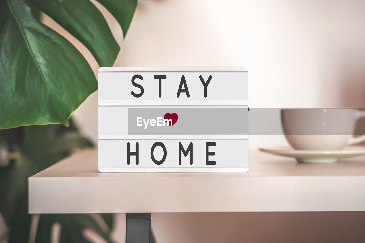 Stay at home text on lightbox in home interior. healthcare, medical and quarantine concept.