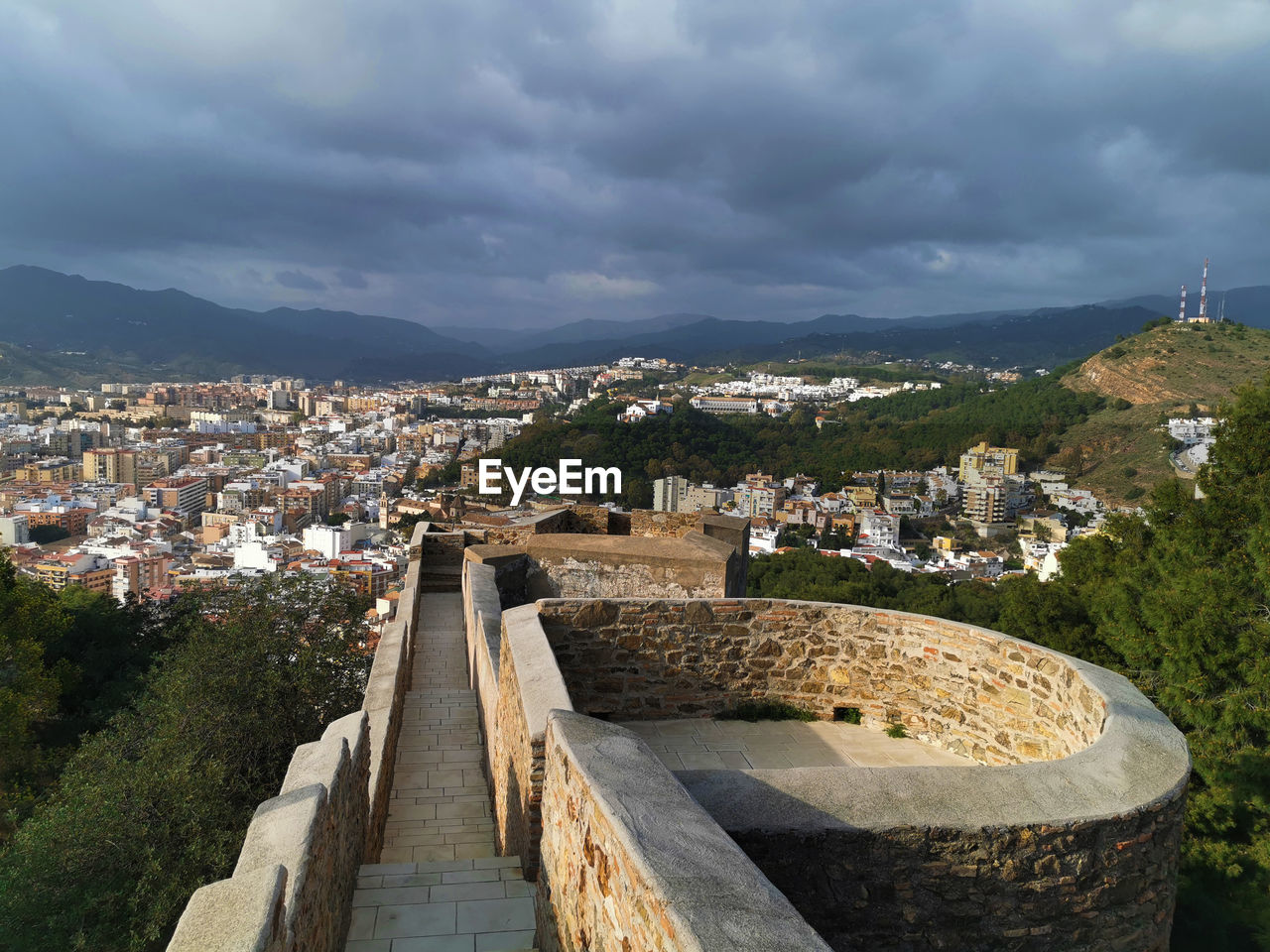 HIGH ANGLE VIEW OF TOWNSCAPE BY TREE AGAINST SKY