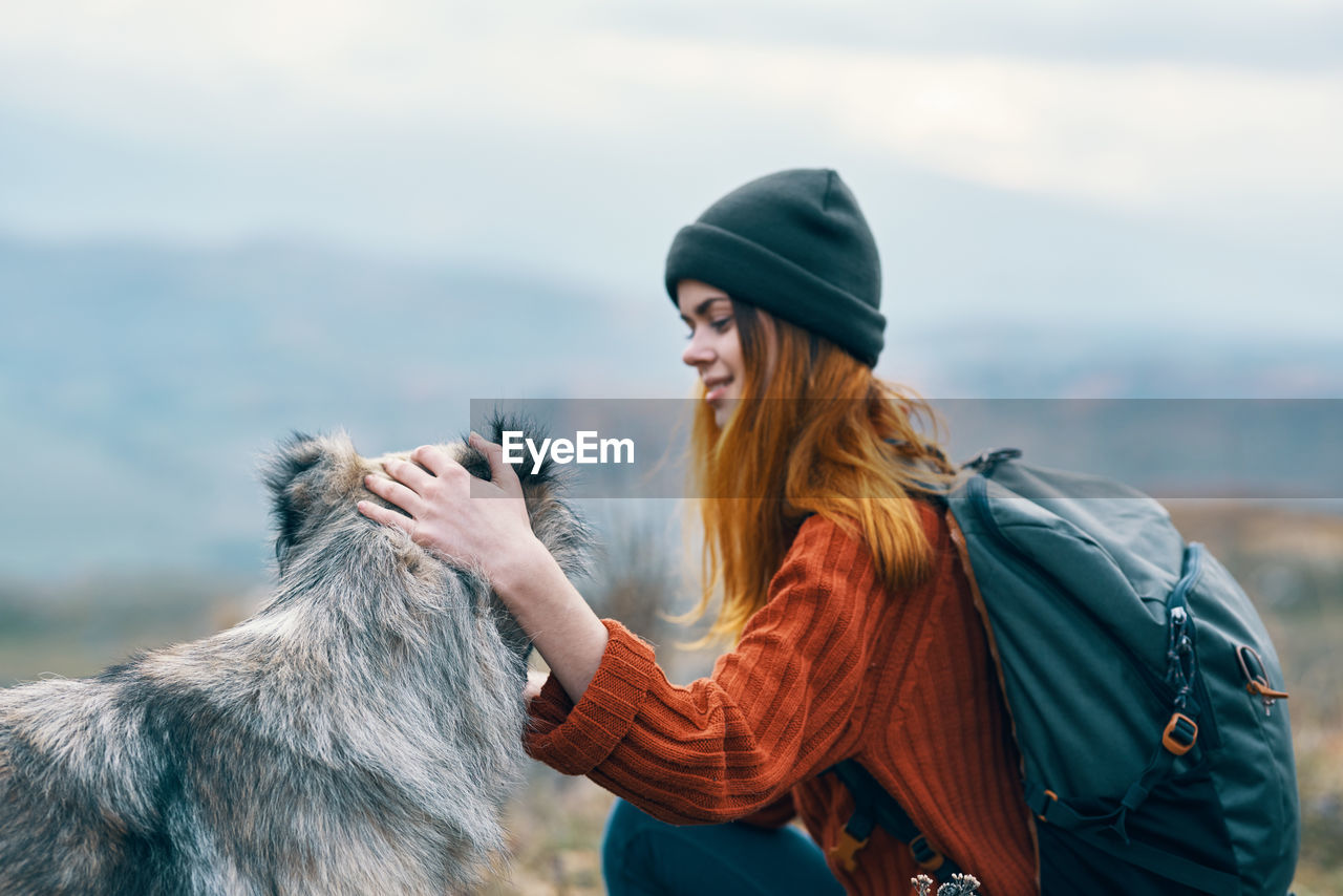 WOMAN WEARING HAT AGAINST SKY