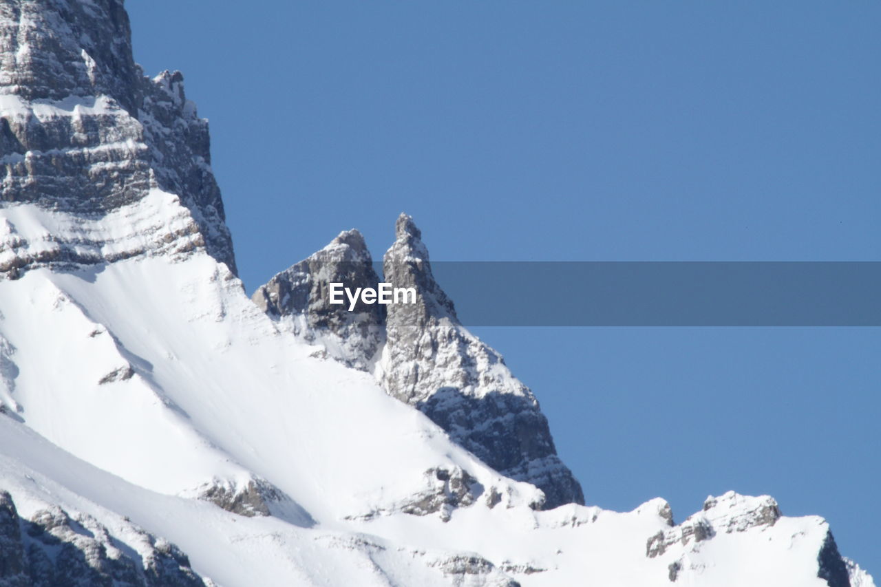 LOW ANGLE VIEW OF MOUNTAIN AGAINST CLEAR SKY