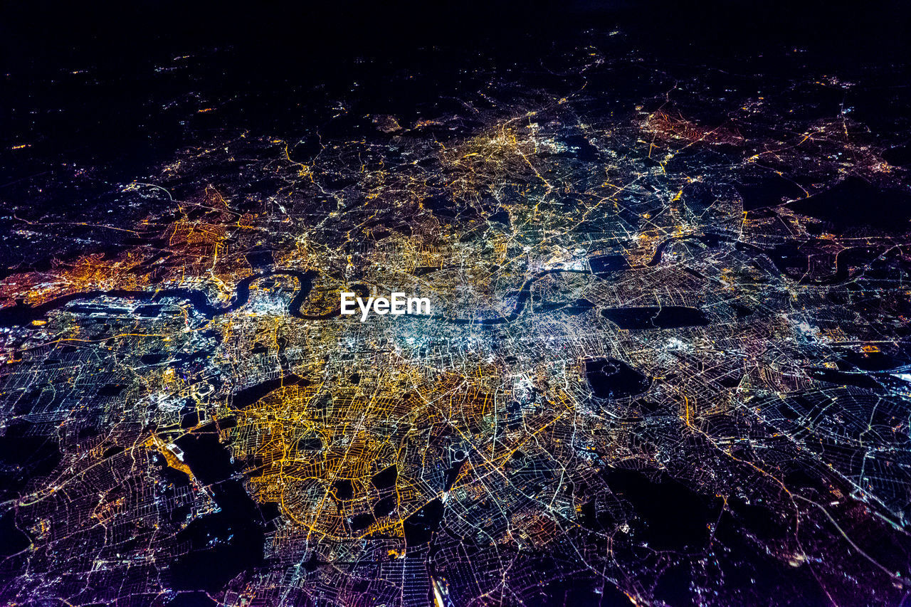 Full frame shot of illuminated city against sky at night