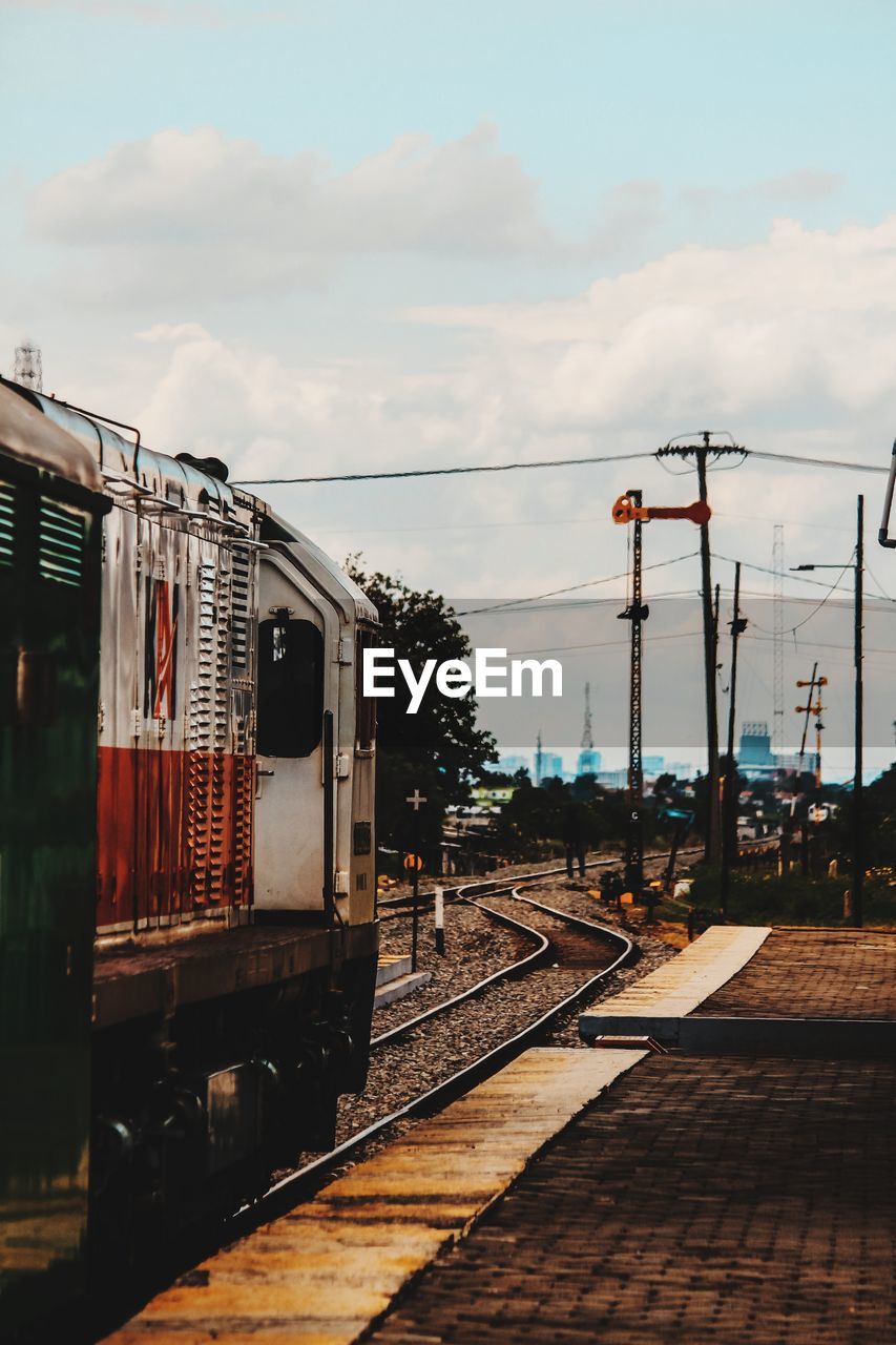 Train on railroad track against sky