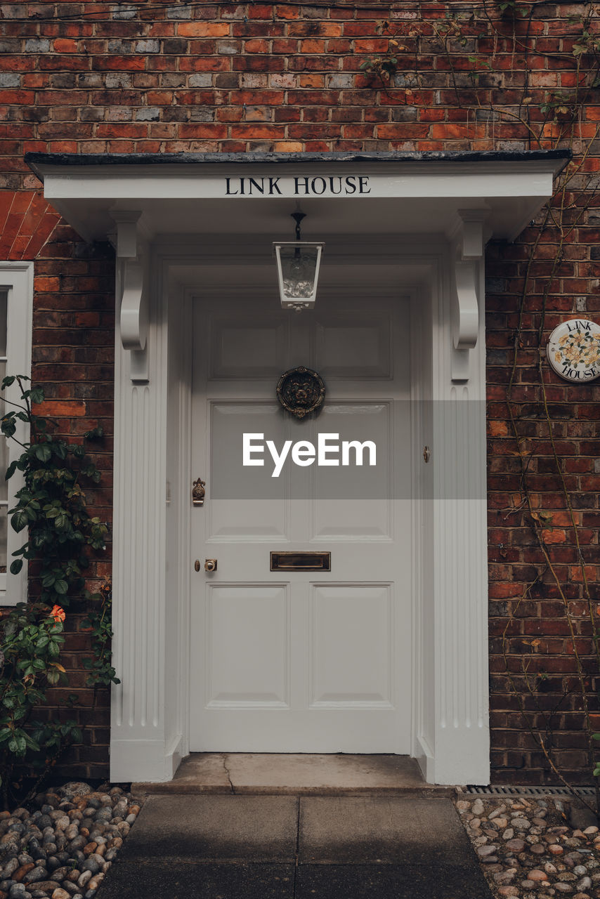 Front door with a metal door knocker of a traditional english house in rye, uk.