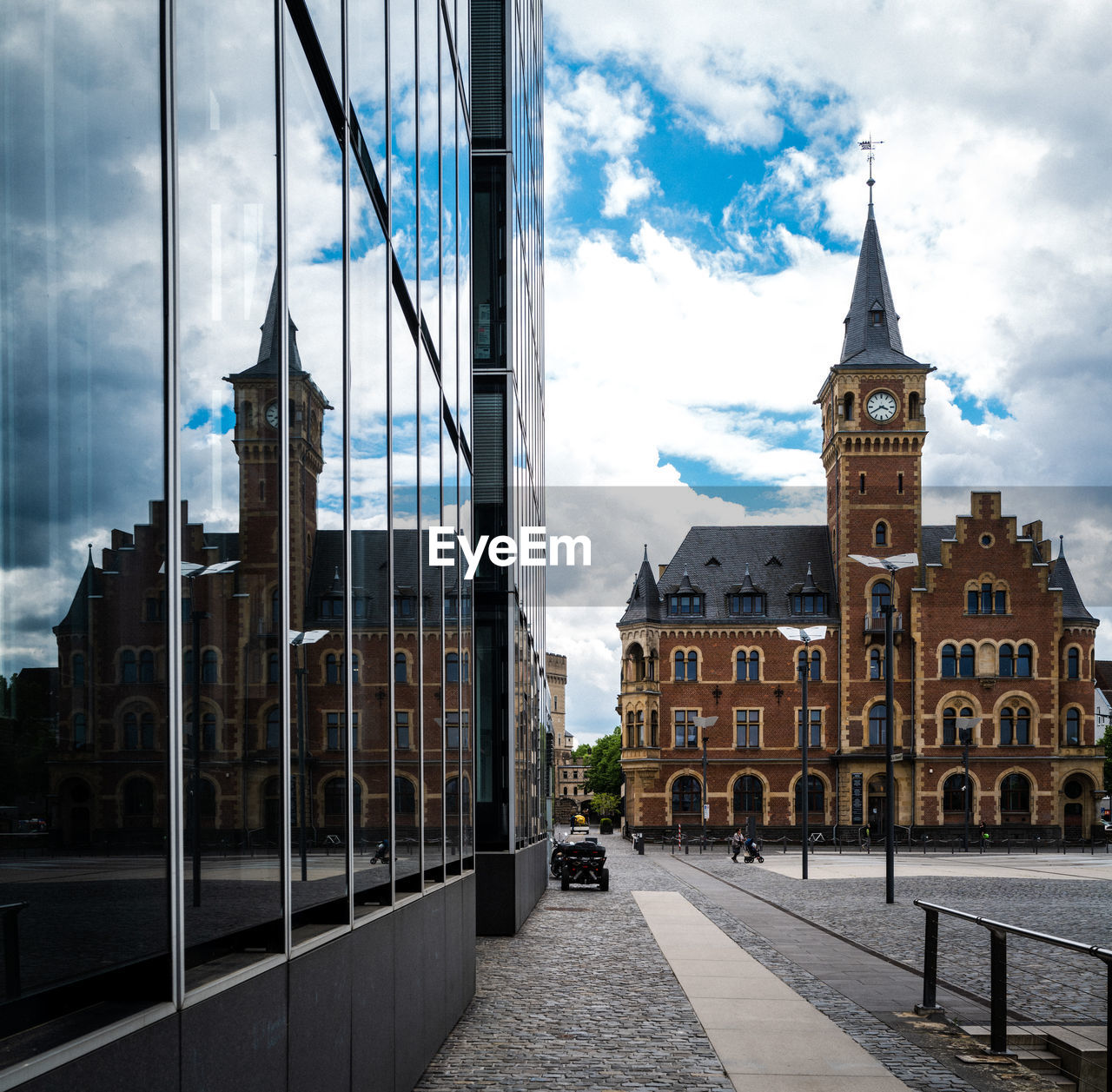 Buildings in city of cologne against cloudy sky