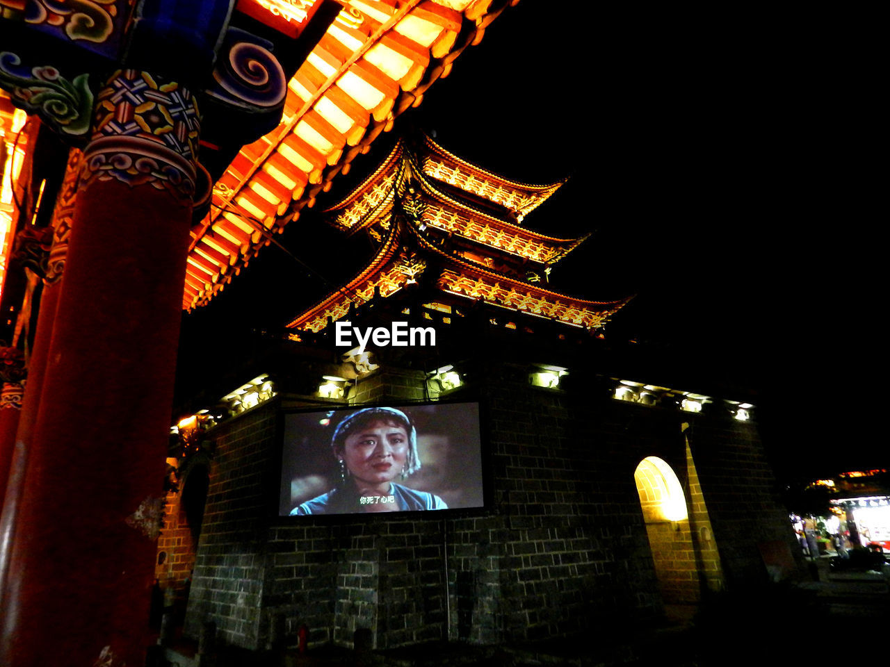 LOW ANGLE VIEW OF ILLUMINATED BUILDING AGAINST SKY